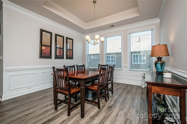 70 Cameo Dr, Flat Rock, NC 28731 - dining room with dark wood finished floors, a chandelier, a decorative wall, a tray ceiling, and a wainscoted wall