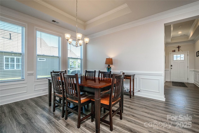 70 Cameo Dr, Flat Rock, NC 28731 - dining space with a decorative wall, a raised ceiling, a chandelier, dark wood-type flooring, and plenty of natural light
