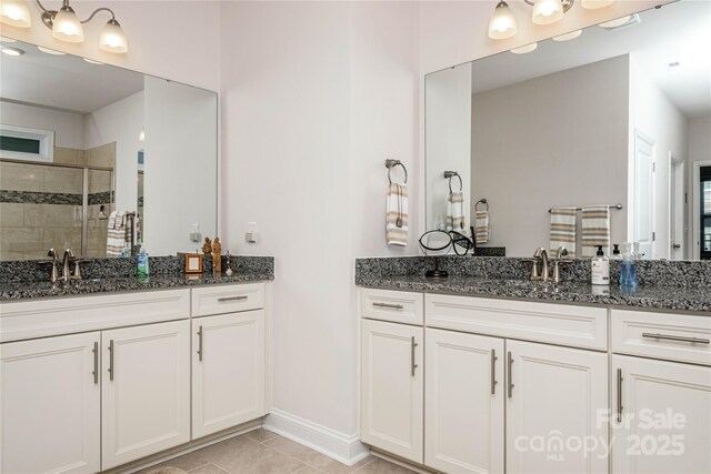 70 Cameo Dr, Flat Rock, NC 28731 - bathroom featuring a stall shower, two vanities, and tile patterned flooring