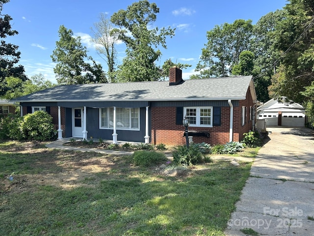 single story home with brick siding, a chimney, roof with shingles, a detached garage, and an outdoor structure