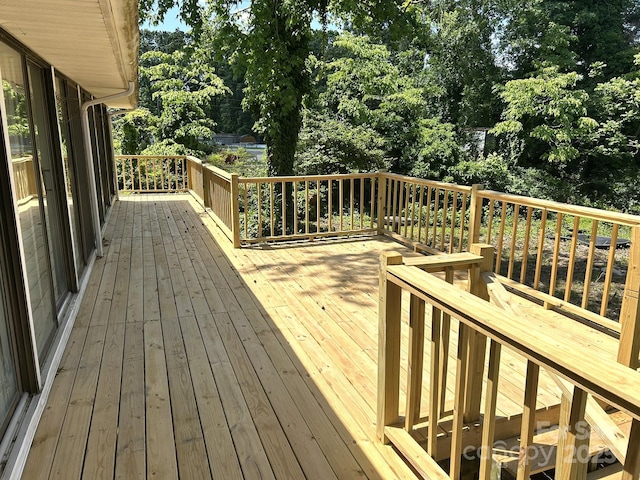 wooden terrace with view of scattered trees