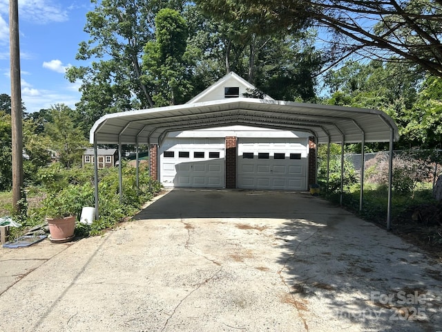 view of car parking with a garage, a carport, and driveway