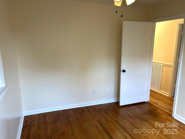 unfurnished bedroom with dark wood-style floors and baseboards