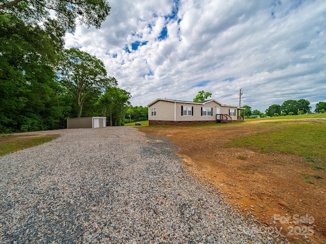 manufactured / mobile home with crawl space and gravel driveway