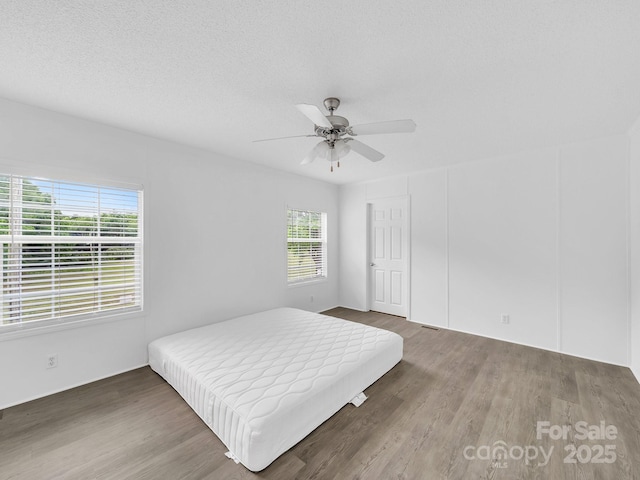 bedroom with ceiling fan and wood finished floors