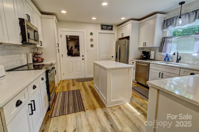 kitchen with recessed lighting, appliances with stainless steel finishes, decorative backsplash, and a sink