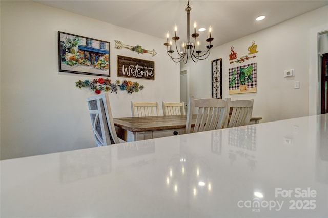 dining space featuring recessed lighting and an inviting chandelier