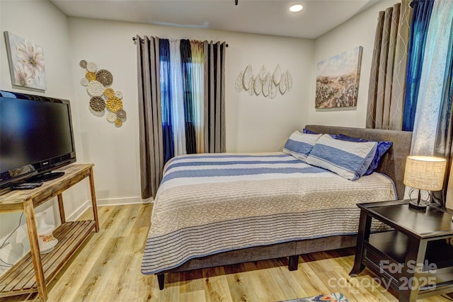bedroom with recessed lighting, baseboards, and light wood finished floors