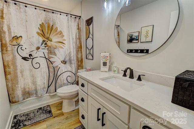 full bath with vanity, wood finished floors, shower / bath combo, and toilet