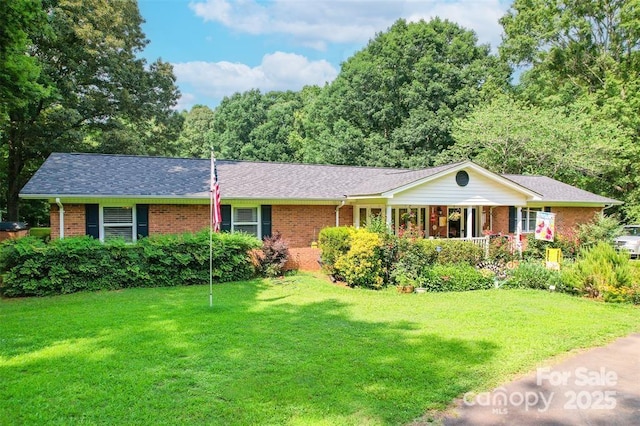 4805 Nesbit Rd, Monroe, NC 28112 - single story home with a shingled roof, a front yard, a porch, and brick siding