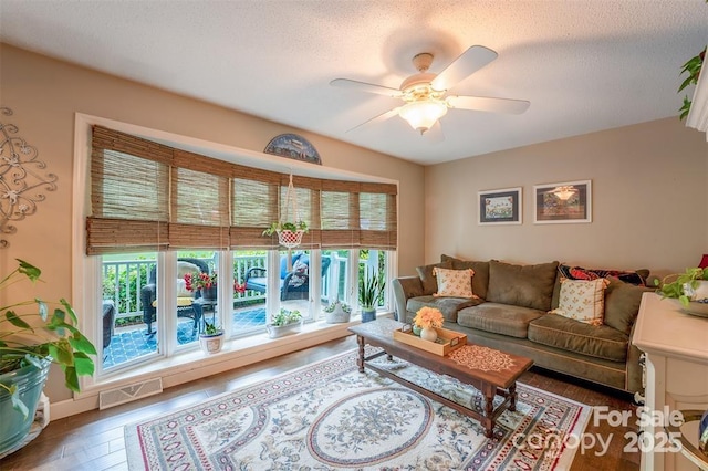 4805 Nesbit Rd, Monroe, NC 28112 - living room with a textured ceiling, ceiling fan, visible vents, and wood finished floors