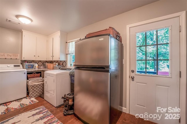 4805 Nesbit Rd, Monroe, NC 28112 - washroom with washer and dryer, plenty of natural light, wood finished floors, and visible vents