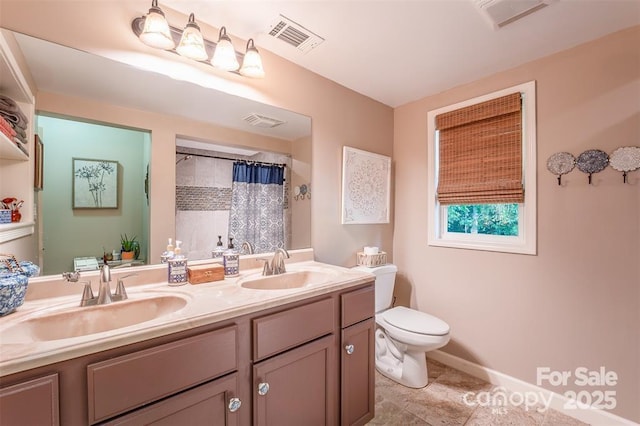 4805 Nesbit Rd, Monroe, NC 28112 - bathroom featuring visible vents, a sink, double vanity, and toilet