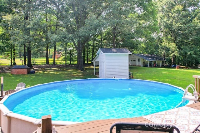 4805 Nesbit Rd, Monroe, NC 28112 - outdoor pool with a yard, a deck, an outdoor structure, and a storage unit