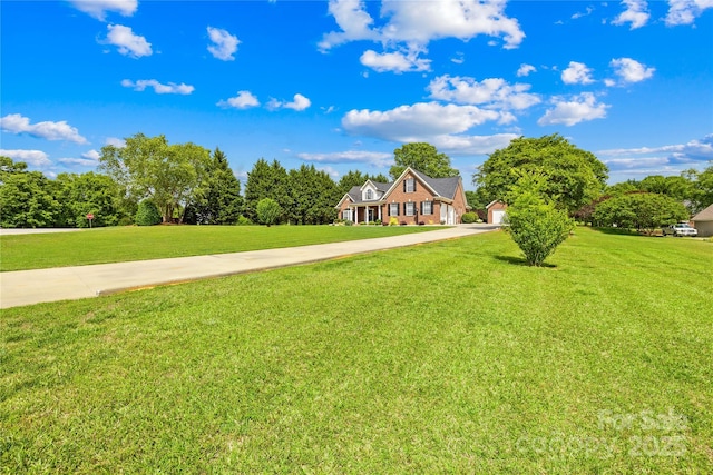 view of yard featuring concrete driveway and a garage
