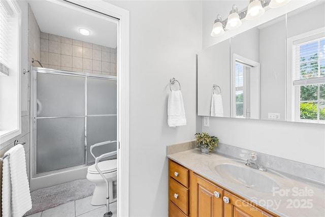 bathroom with vanity, tile patterned flooring, a shower stall, and toilet