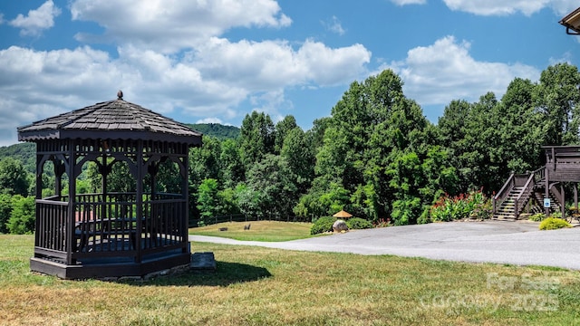 view of home's community with a gazebo, a lawn, and a deck