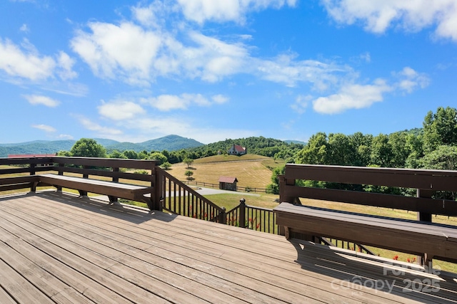 wooden deck featuring a rural view and a mountain view