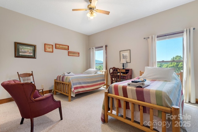 bedroom featuring light colored carpet and ceiling fan