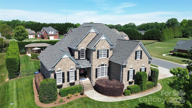 3000 J R Ct, Stanley, NC 28164 - traditional-style house featuring brick siding, a front lawn, fence, and concrete driveway