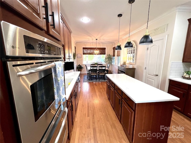 3000 J R Ct, Stanley, NC 28164 - kitchen with pendant lighting, a center island, light countertops, light wood-style floors, and oven