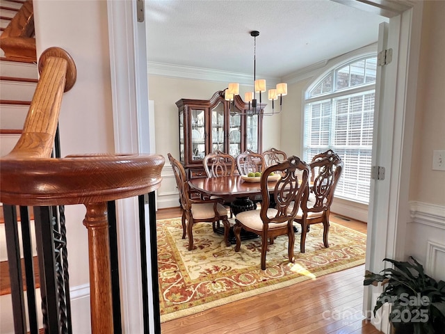 3000 J R Ct, Stanley, NC 28164 - dining room featuring wood-type flooring, crown molding, an inviting chandelier, and visible vents