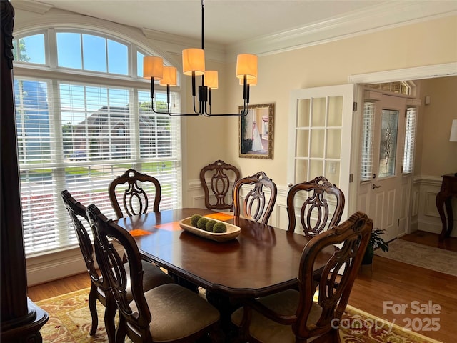 3000 J R Ct, Stanley, NC 28164 - dining space with an inviting chandelier, ornamental molding, light wood-style floors, and plenty of natural light