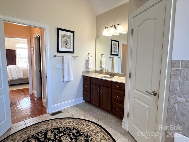 3000 J R Ct, Stanley, NC 28164 - ensuite bathroom with vanity, tile patterned floors, ensuite bathroom, lofted ceiling, and visible vents