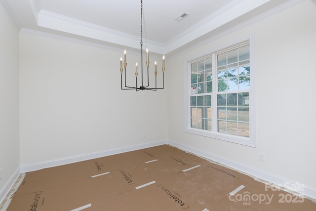 unfurnished dining area featuring baseboards, ornamental molding, and a notable chandelier