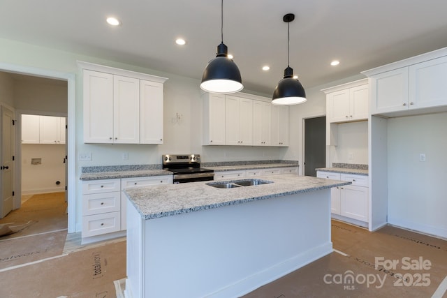 kitchen featuring stainless steel electric range oven, white cabinets, a center island with sink, and recessed lighting