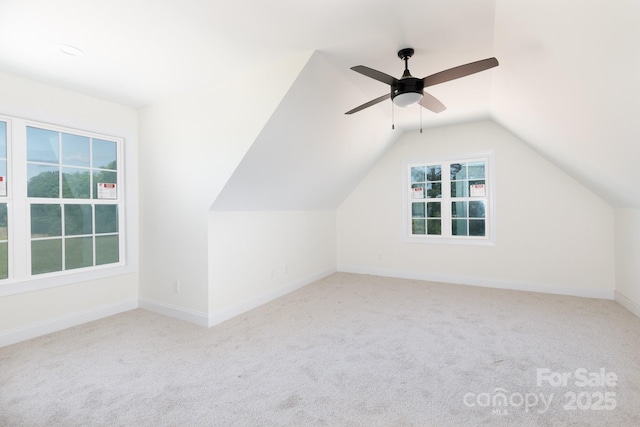 bonus room with carpet flooring, a wealth of natural light, and lofted ceiling
