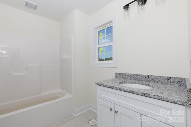 full bath with baseboards, visible vents, tub / shower combination, and vanity