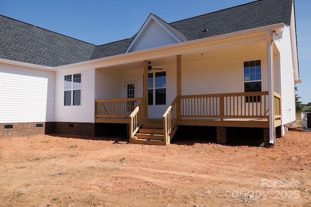 back of house featuring crawl space, central AC, and roof with shingles