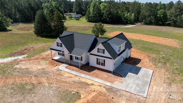 drone / aerial view featuring a view of trees