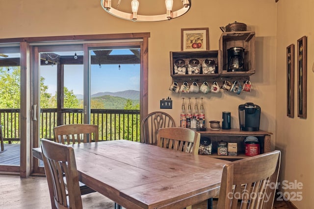 dining space featuring a mountain view, wood finished floors, and a wealth of natural light
