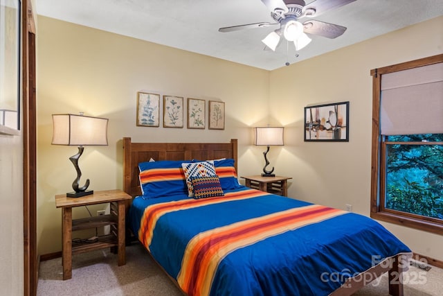 carpeted bedroom featuring baseboards and a ceiling fan