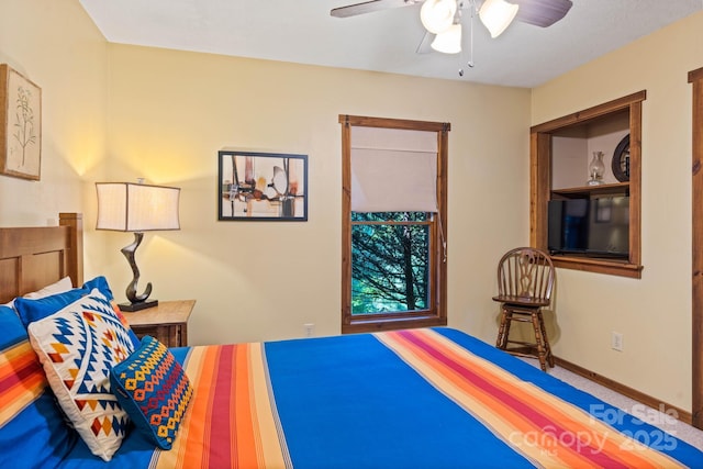 bedroom featuring ceiling fan and baseboards