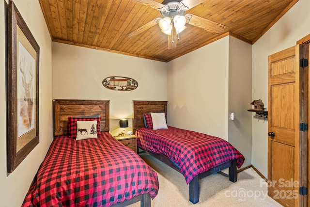 carpeted bedroom featuring crown molding, a ceiling fan, and wooden ceiling