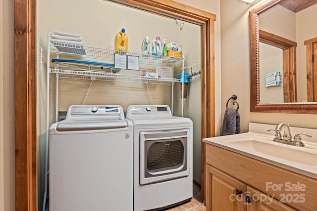 clothes washing area featuring separate washer and dryer and a sink
