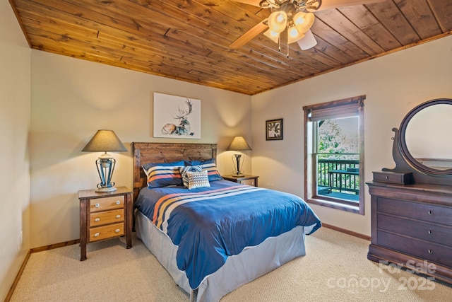 carpeted bedroom featuring a ceiling fan, baseboards, access to exterior, and wood ceiling