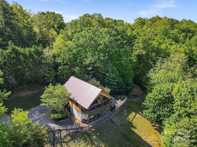 drone / aerial view featuring a wooded view