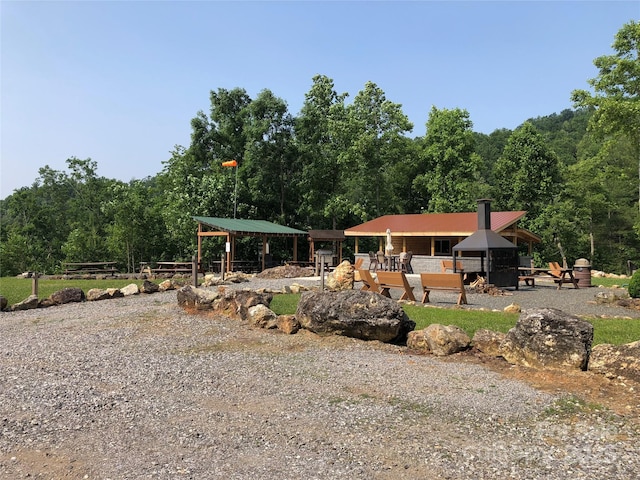 exterior space featuring a wooded view