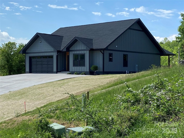 15 Woodchuck Cv, Alexander, NC 28701 - modern inspired farmhouse with driveway, a garage, and a shingled roof