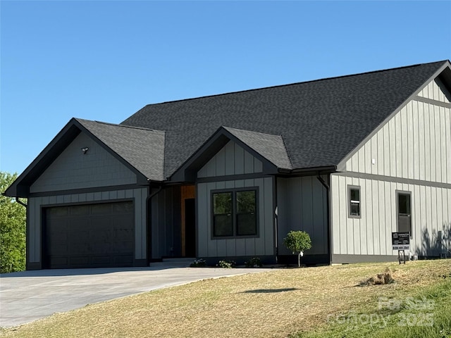 15 Woodchuck Cv, Alexander, NC 28701 - modern farmhouse with an attached garage, a shingled roof, and board and batten siding