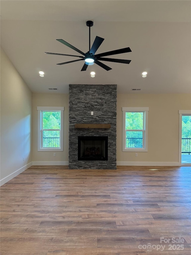 15 Woodchuck Cv, Alexander, NC 28701 - unfurnished living room featuring wood finished floors, healthy amount of natural light, ceiling fan, lofted ceiling, and recessed lighting