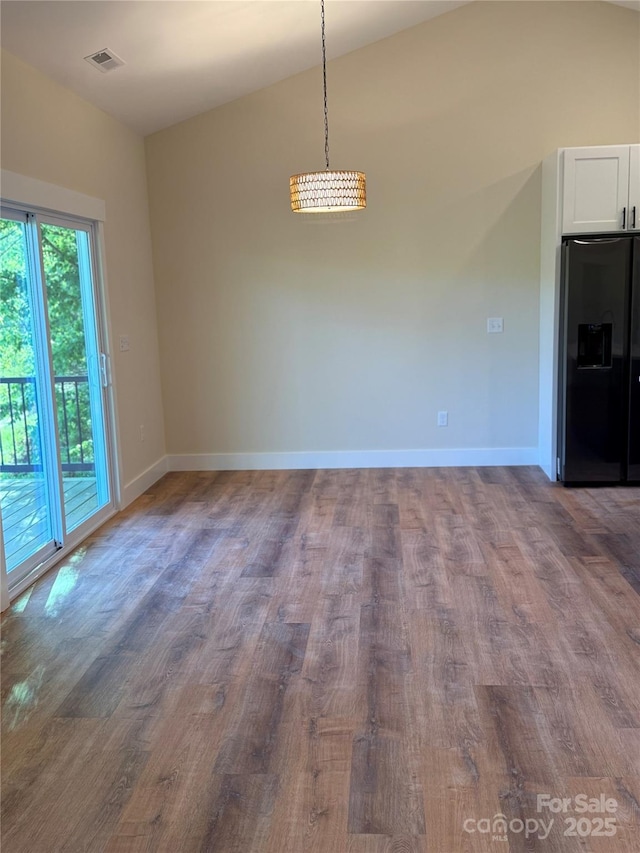 15 Woodchuck Cv, Alexander, NC 28701 - unfurnished dining area with wood finished floors, baseboards, and lofted ceiling
