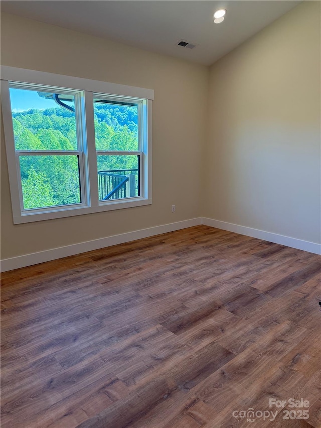 15 Woodchuck Cv, Alexander, NC 28701 - unfurnished room with wood finished floors, baseboards, and recessed lighting