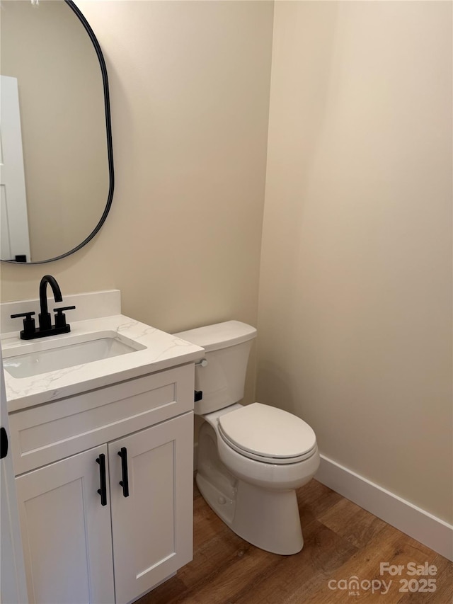 15 Woodchuck Cv, Alexander, NC 28701 - bathroom with wood finished floors, toilet, vanity, and baseboards