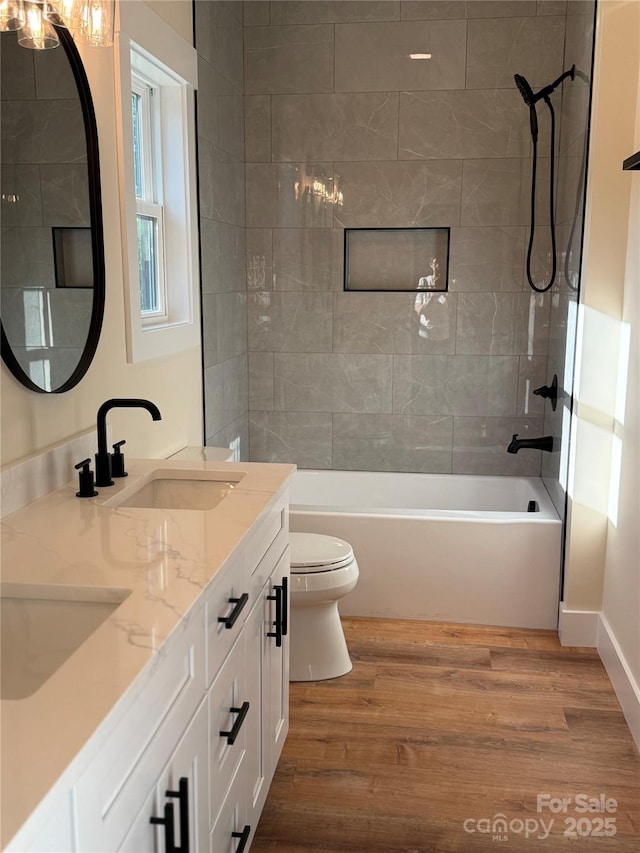 15 Woodchuck Cv, Alexander, NC 28701 - bathroom with toilet, washtub / shower combination, wood finished floors, double vanity, and baseboards