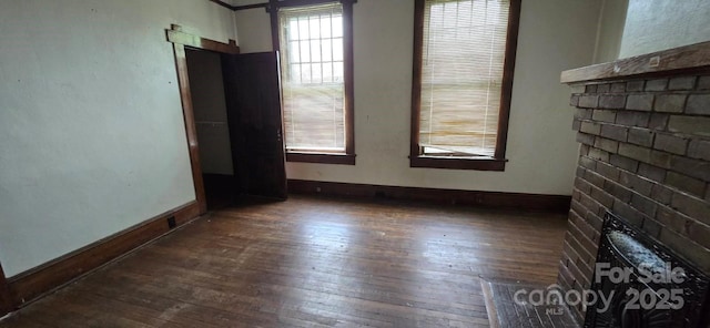 empty room featuring wood-type flooring and baseboards